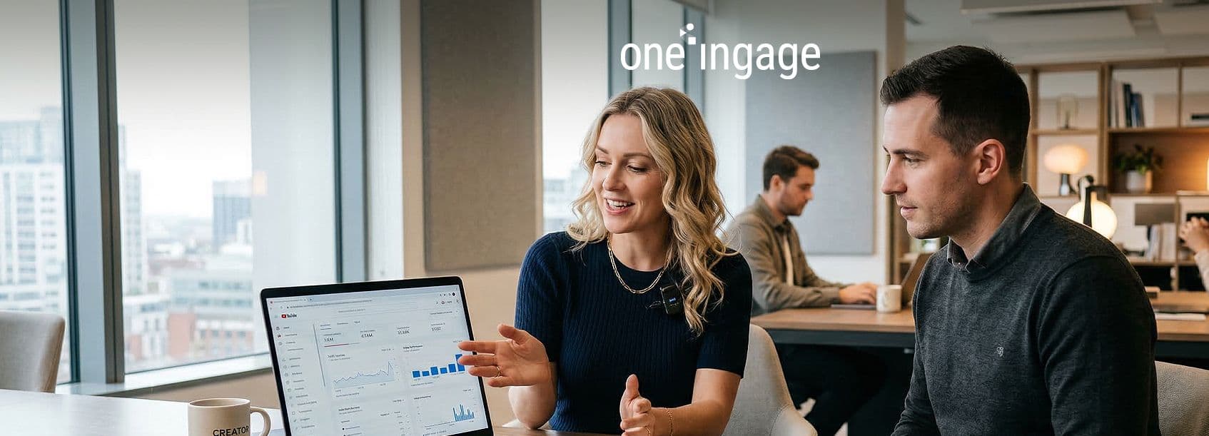 A person sits at a desk optimizing a YouTube video title, description, and tags on their computer.